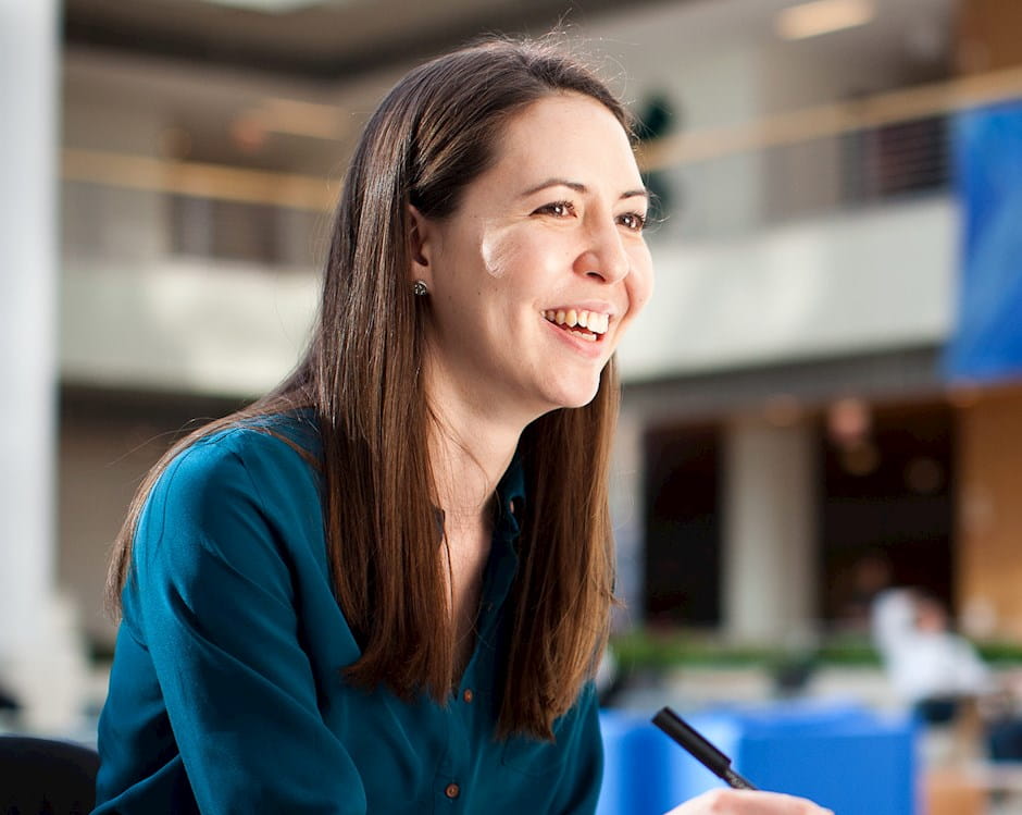 Female student smiling, in conversation